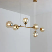 Modern brass glass ball chandelier with six smoked glass globe shades for living room dining decor by decorbites brass glass