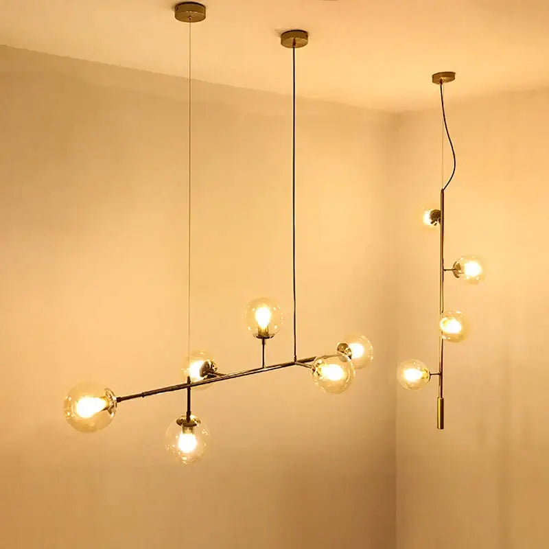 Modern brass glass ball chandelier with multiple spherical bulbs in asymmetrical branch design for living room decor