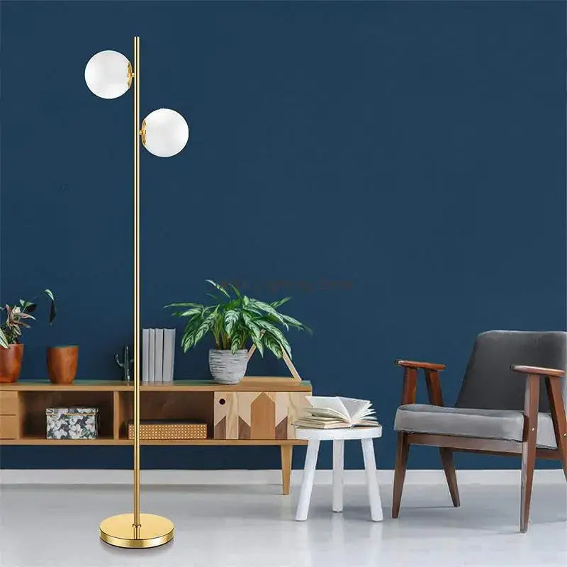 Modern brass glass ball floor lamp with gold finish and two white spherical glass shades for bedroom and study decorbites floor lamp