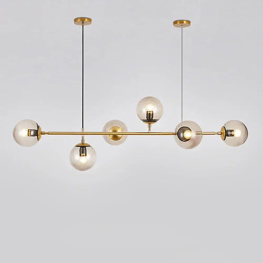 Modern brass glass ball led chandelier with five clear glass globe bulbs suspended by black cords for dining room decorbites