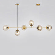 Modern brass glass ball led chandelier with five clear glass globe bulbs suspended by black cords for dining room decorbites