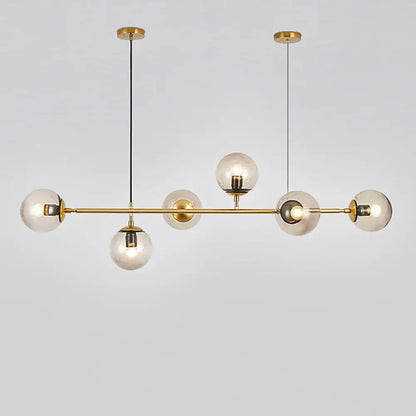 Modern brass glass ball led chandelier with five clear glass globe bulbs suspended by black cords for dining room decorbites