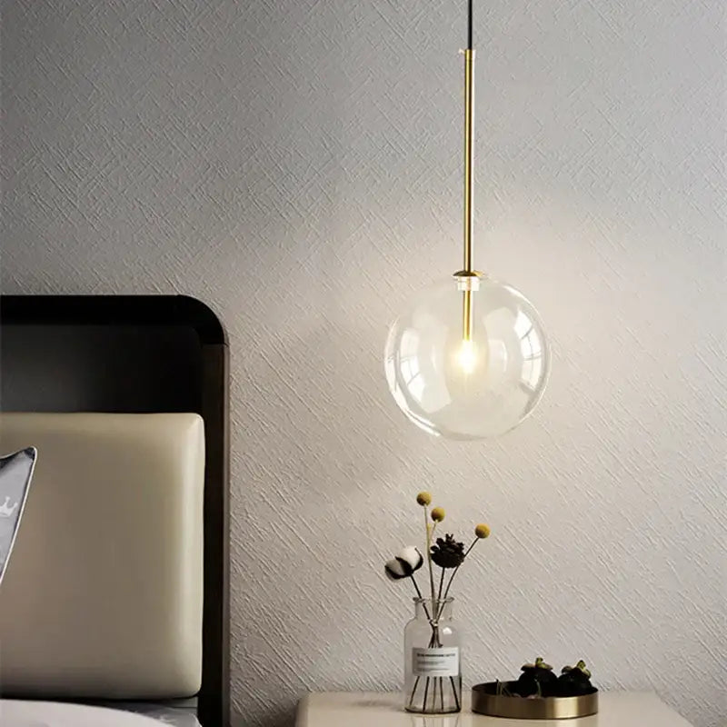 Modern brass glass ball led pendant lamp with clear glass globe and slender brass rod for living room lighting decorbites glass ball
