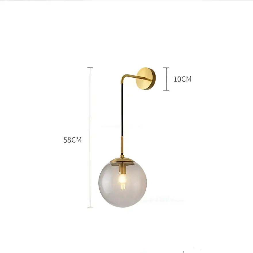 A modern brass glass ball led wall light with gold metal arm and smoked glass globe for stylish bedroom decorbites wall light