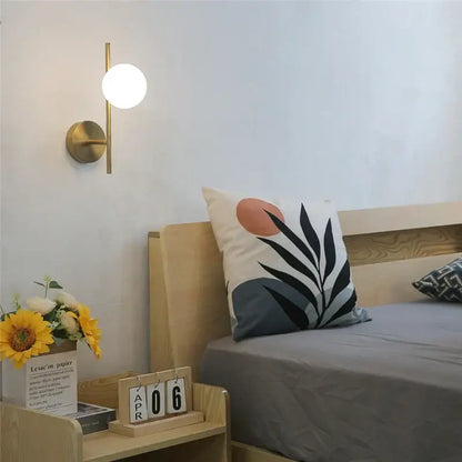 Modern brass glass ball led wall sconce with a spherical white glass shade for stylish bedroom decorbites glass ball lighting