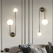 Modern brass glass ball led wall light featuring gold-toned metal arms and frosted glass globe shades for bedroom decorbites wall light
