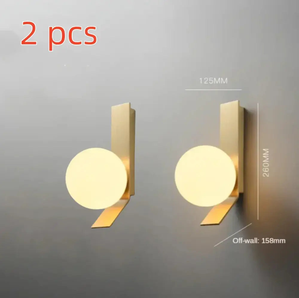 Modern brass glass ball led wall sconce with gold finish and circular softly glowing light for bedroom decorbites glass ball