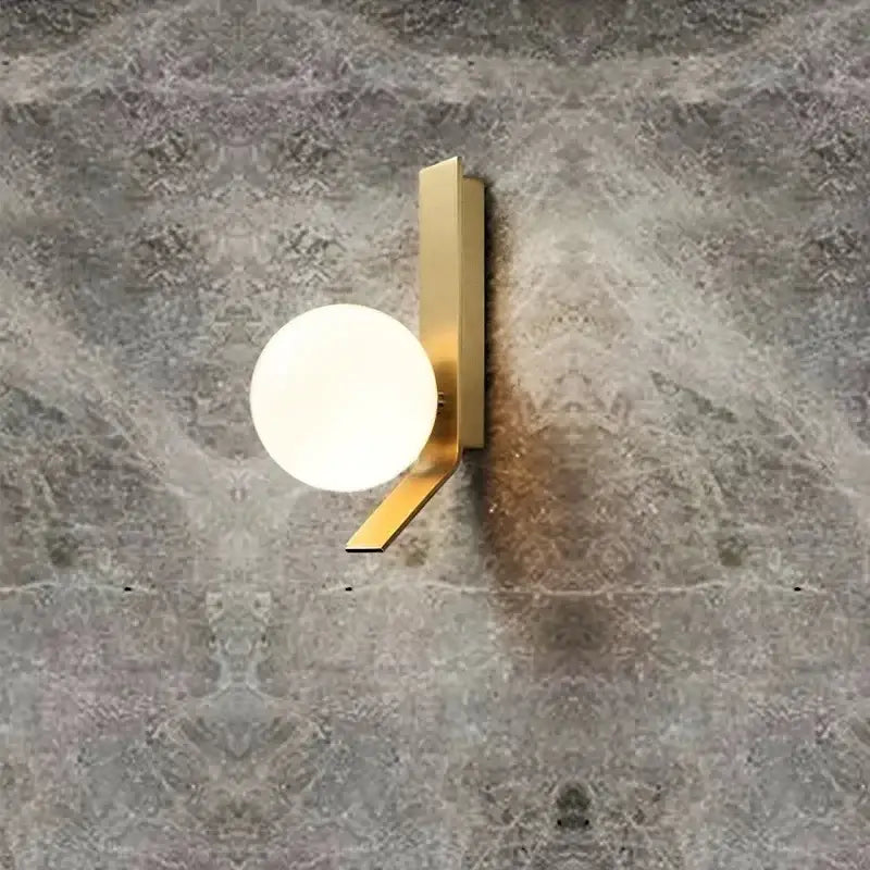 Modern brass glass ball led wall sconce with gold-toned angular metal frame and round frosted glass diffuser for bedroom decorbites glass ball