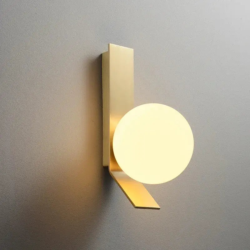 Modern brass glass ball led wall sconce with sleek rectangular backplate and softly glowing glass ball shade for bedroom decorbites