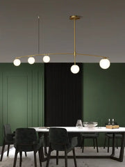 Modern brass glass ball pendant chandelier with five white glass bulbs arranged in an elegant curved arc for dining room decorbites glass ball