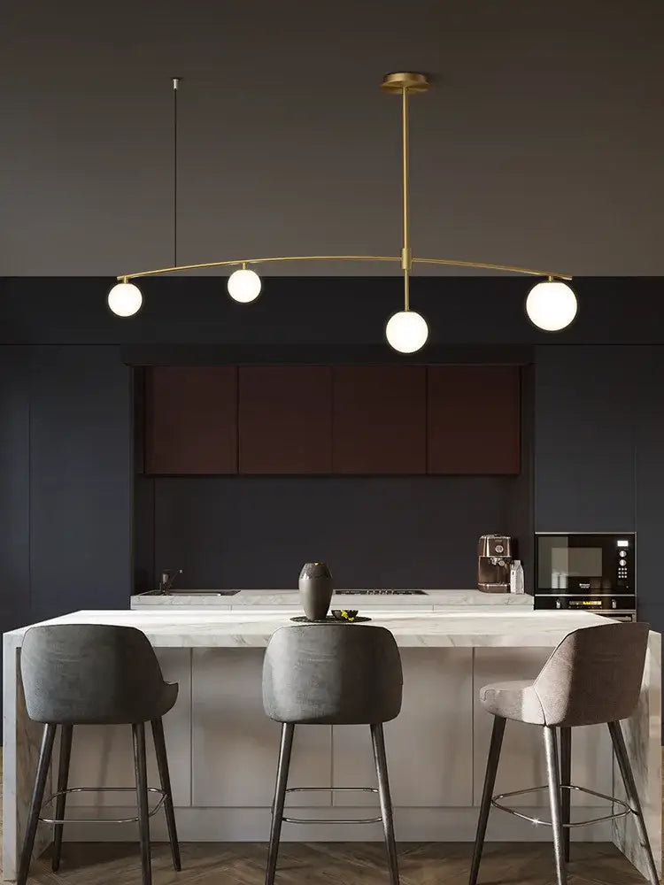 Modern brass glass ball pendant chandelier with four white globe bulbs for dining room decorbites glass ball design
