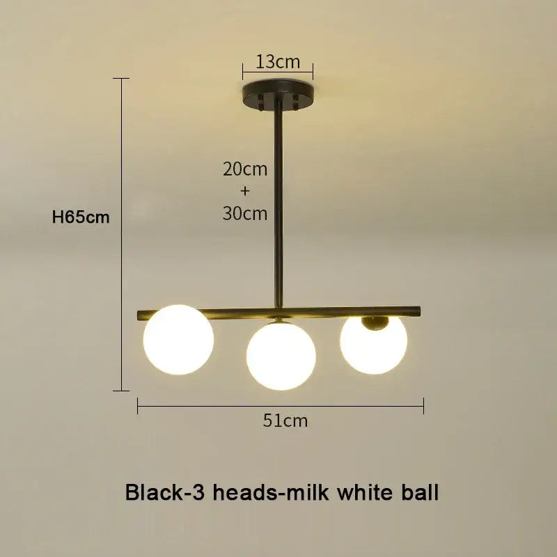 Modern brass glass ball pendant chandelier with black finish and three milk-white glass ball pendant bulbs for dining room decorbites