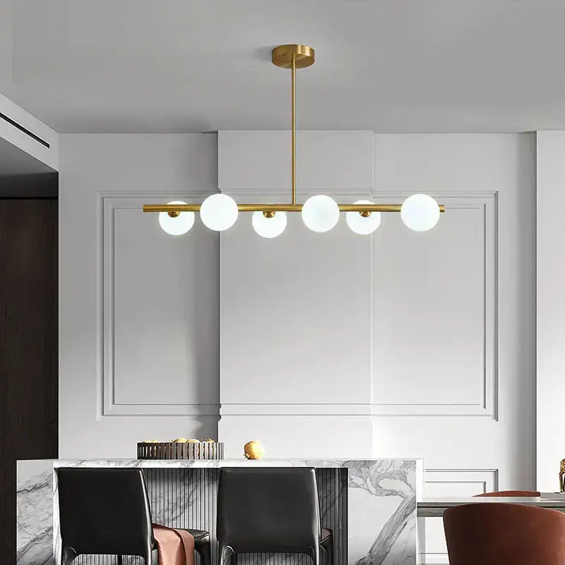 Modern brass glass ball pendant chandelier with five frosted glass globe bulbs in gold-toned linear design for dining room decorbites glass ball pendant