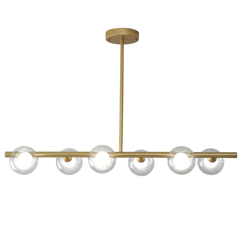 Modern brass glass ball pendant chandelier featuring six clear glass globe bulbs in a linear design for dining room decorbites glass ball
