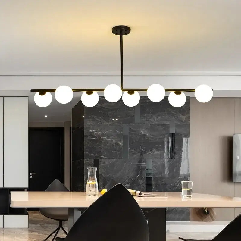 Modern black metal ball pendant chandelier with seven frosted glass globe bulbs for elegant dining room decorbites glass ball