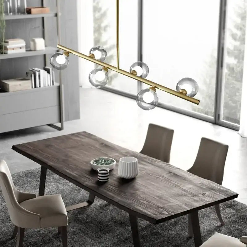 Modern brass glass ball pendant chandelier featuring clear glass globe bulbs ideal for dining room lighting decorbites glass ball