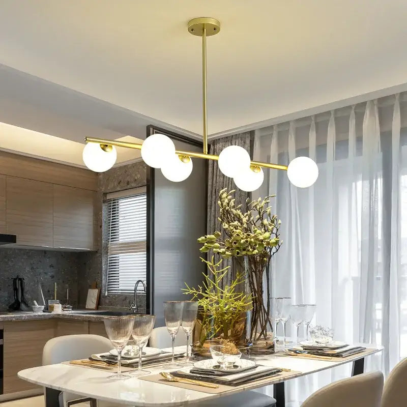 Modern brass glass ball pendant chandelier with five white glass bulbs in gold tone perfect for dining room decorbites glass ball