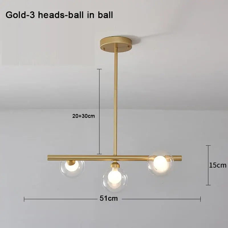 Modern brass glass ball pendant chandelier with gold-toned frame and three spherical glass shades for dining room decorbites glass ball