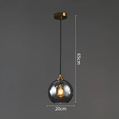A sleek 65cm modern brass glass ball pendant light with smoked glass globe for dining and kitchen decorbites