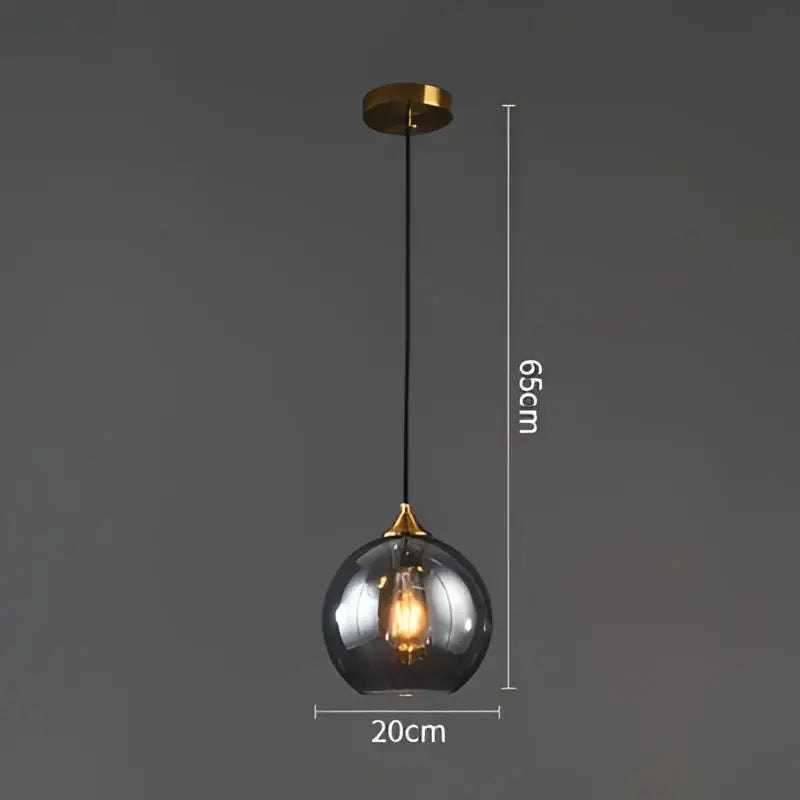 A sleek 65cm modern brass glass ball pendant light with smoked glass globe for dining and kitchen decorbites