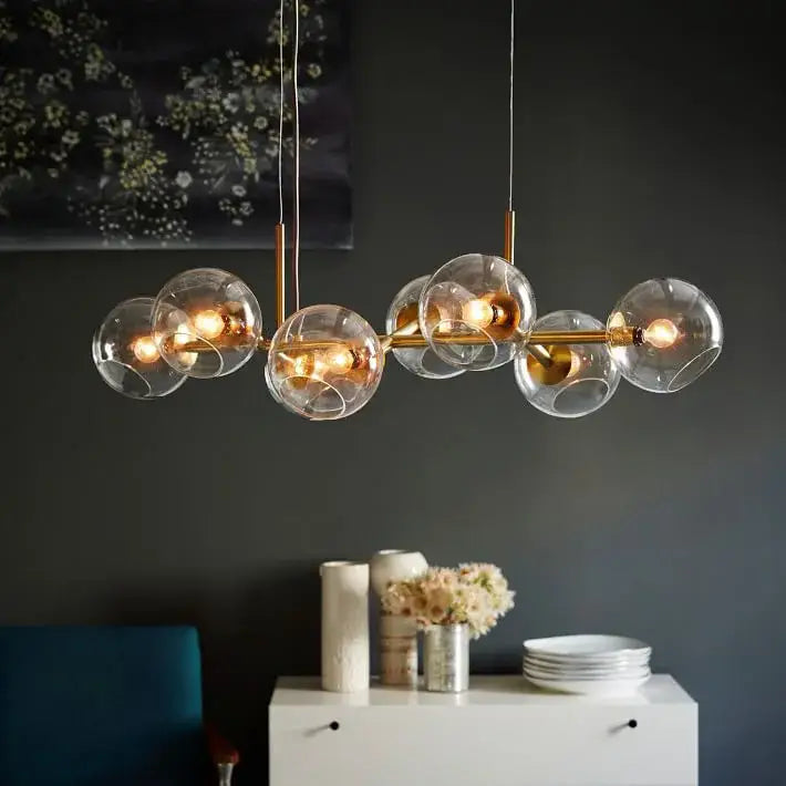 Modern brass glass ball pendant light with clear glass globe bulbs ideal for kitchen decor pendant lights decorbites glass ball