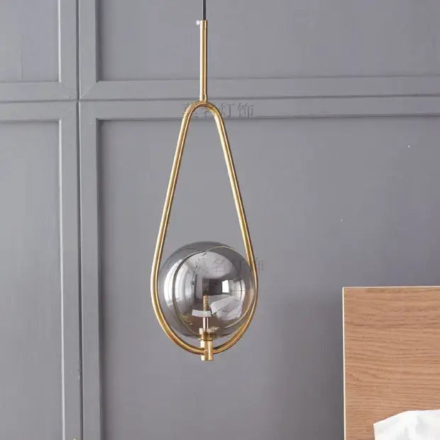 Modern brass glass ball pendant lighting featuring a gold-toned teardrop glass ball pendant for bedroom decorbites glass ball