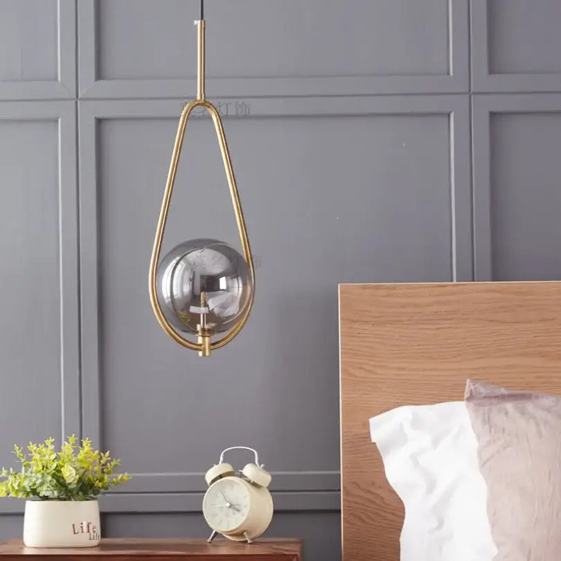 Modern brass glass ball pendant lighting with gold-toned metal frame and reflective glass globe for stylish decorbites glass ball