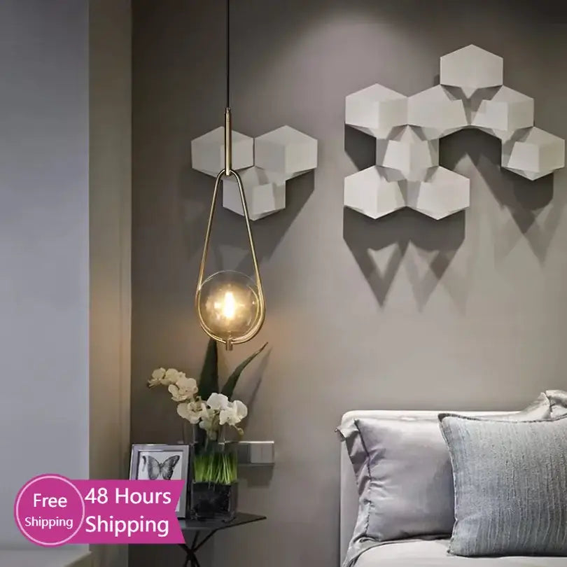 Modern brass glass ball pendant lighting with a spherical glass globe hanging from a slender chain for bedroom decorbites glass ball