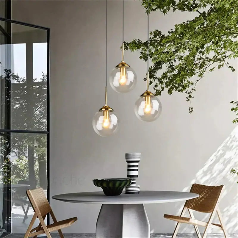 Three modern brass glass ball pendant lights with glass globe shades for dining room decorbites glass ball pendant set
