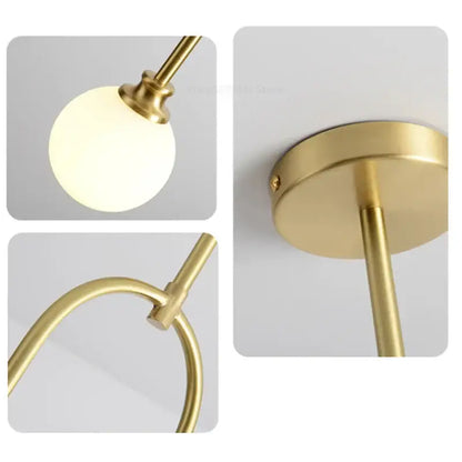 Modern brass glass ball pendant lights featuring gold-finished metal frame and frosted glass ball pendant for dining room decorbites