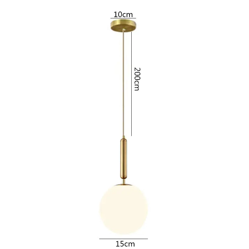 A modern gold-toned decorbites brass glass pendant light with a spherical frosted glass ball shade for kitchen decor