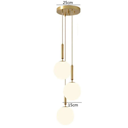 Modern brass glass ball pendant lights featuring gold-toned rods and frosted glass spheres for kitchen decorbites decor