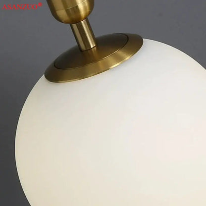 A sleek frosted white glass ball pendant light with polished brass fixture ideal for modern kitchen decorbites brass glass decor