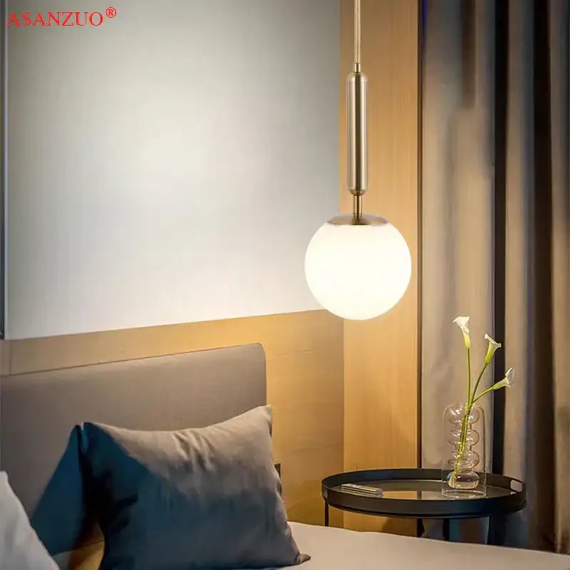 A sleek modern pendant light with brushed brass finish and frosted glass ball for kitchen decorbites brass glass pendant lights