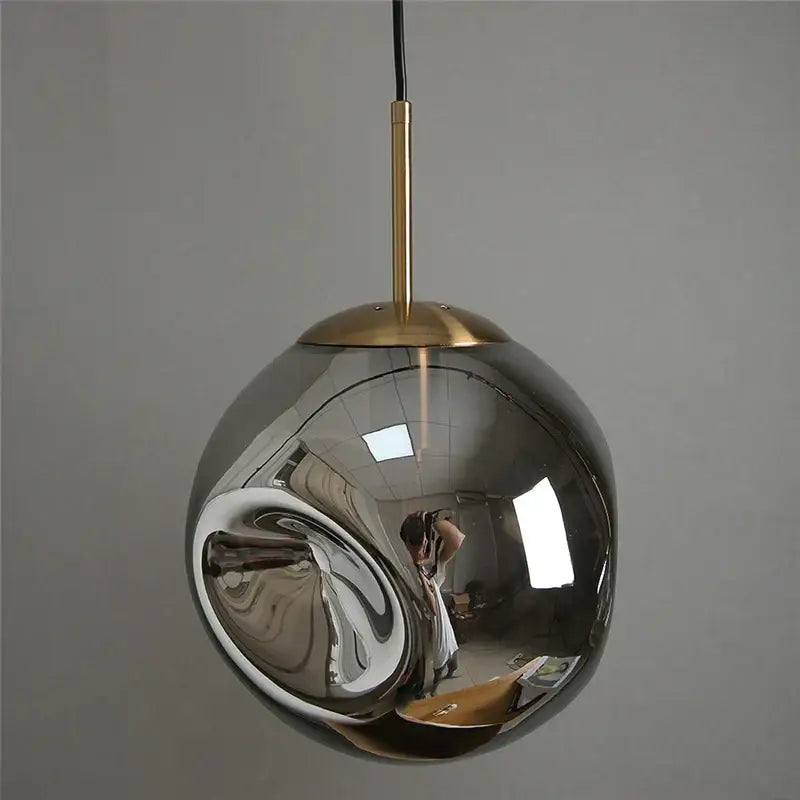 Modern brass glass ball pendant lights set of 2 with sleek spherical chrome finish and brass-toned hanging rod for kitchen decorbites