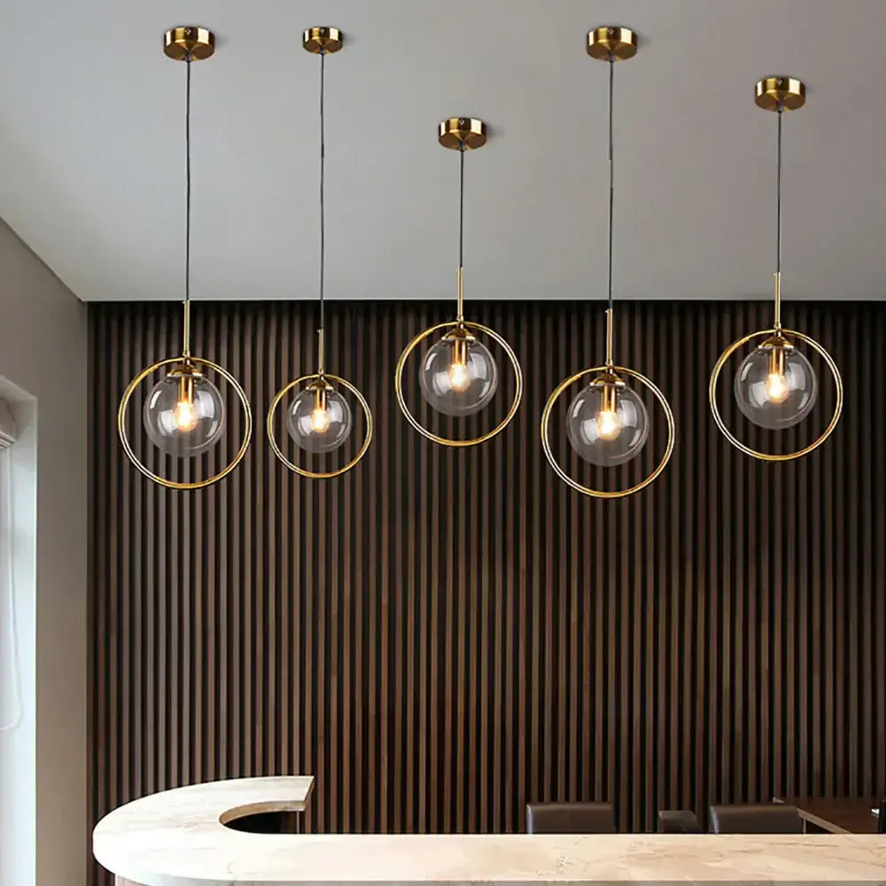 Five modern decorbites glass ball pendant lights with gold-toned brass frames hang as bedroom lighting decorbites glass ball set