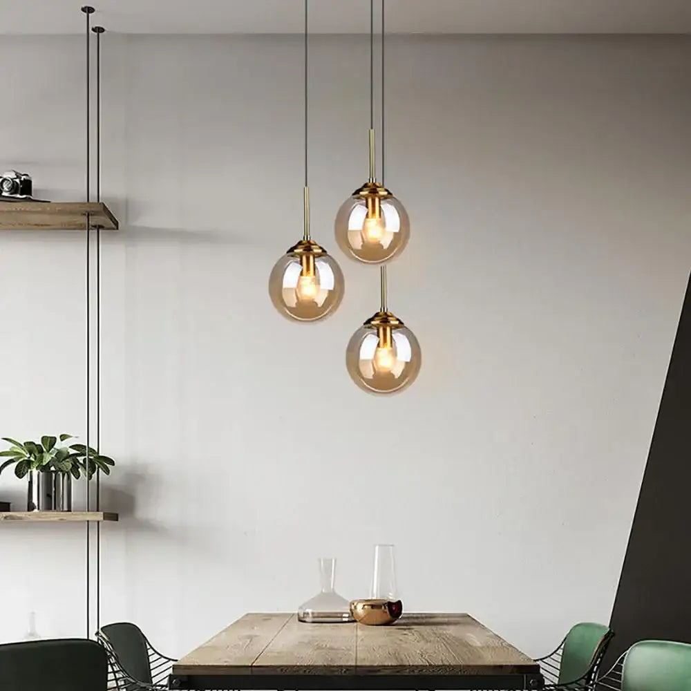 Three spherical amber glass ball pendant lights with brass fixtures for modern bedroom decorbites glass ball set