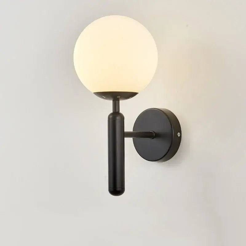 Black metal wall lamp with frosted glass globe from decorbites glass ball wall collection for modern bedroom decor