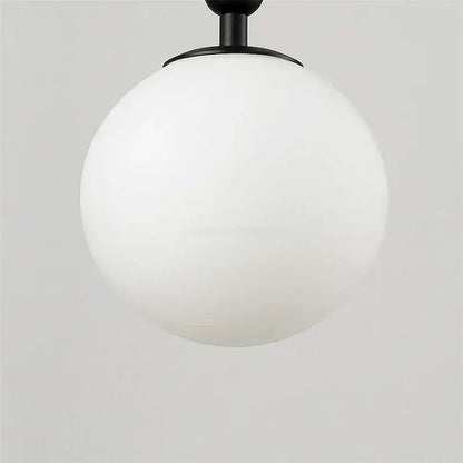 A sleek matte black spherical wall lamp with frosted white glass globe decorbites glass ball wall lamp for bedroom decor