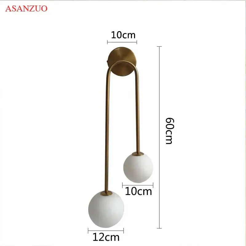 Modern brass glass ball wall sconce with two white matte glass globes and slender brass arms by asanzuo