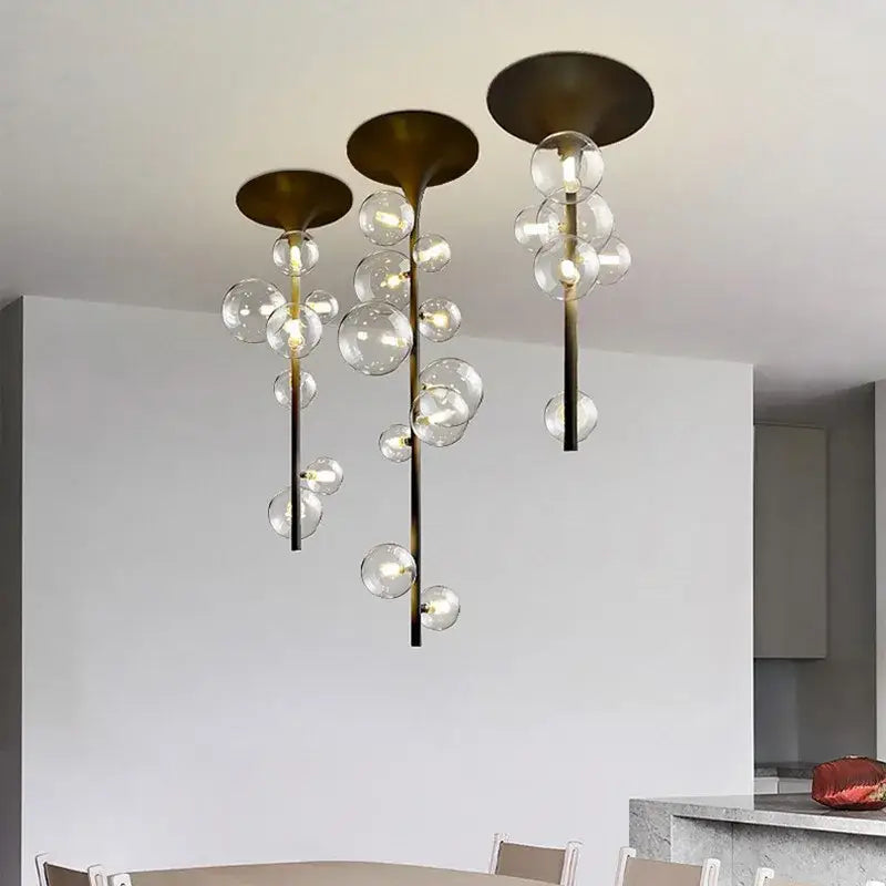 Modern brass glass bubble pendant light featuring cascading clear glass spheres ideal for dining room decorbites pendant light