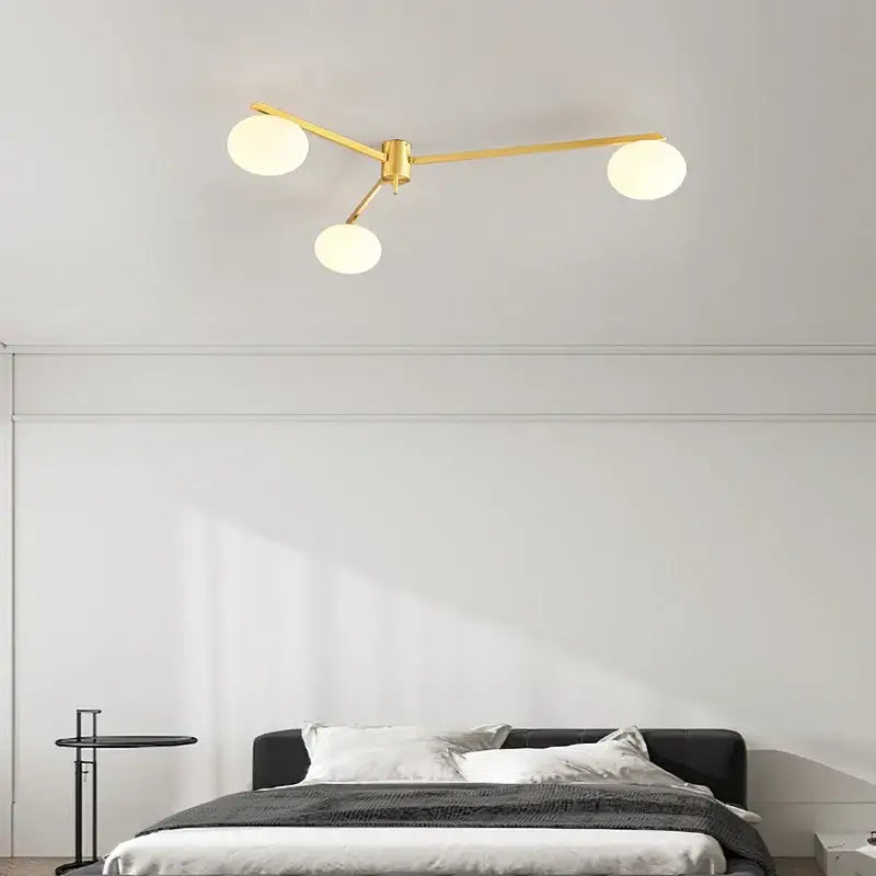 Modern brass glass ceiling lamp with frosted globes featuring gold-toned brass glass decorbites brass glass design