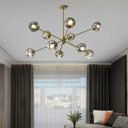 Modern brass glass chandelier with clear glass shades featuring spherical globes for elegant living spaces and dining rooms