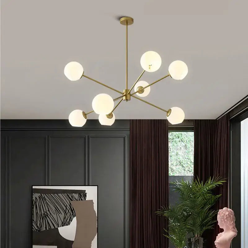 Modern brass glass chandelier with gold-toned frame and eight frosted globe lights for elegant living spaces