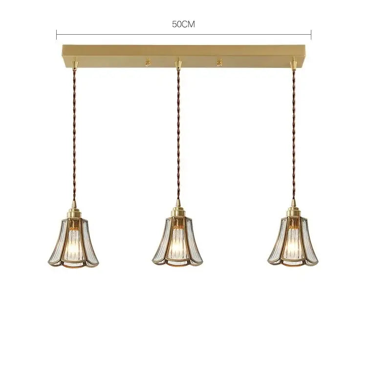 Modern brass glass copper led pendant lights featuring gold-toned three-light fixture with fluted glass shades and twisted copper cords