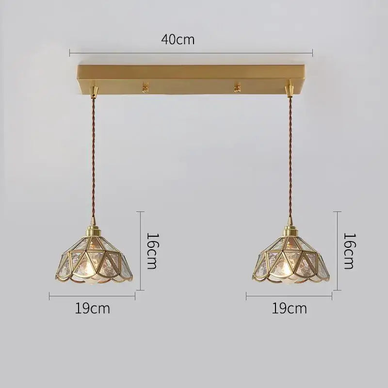 Modern brass pendant lights with geometric faceted glass shades and twisted copper led cords for dining room use