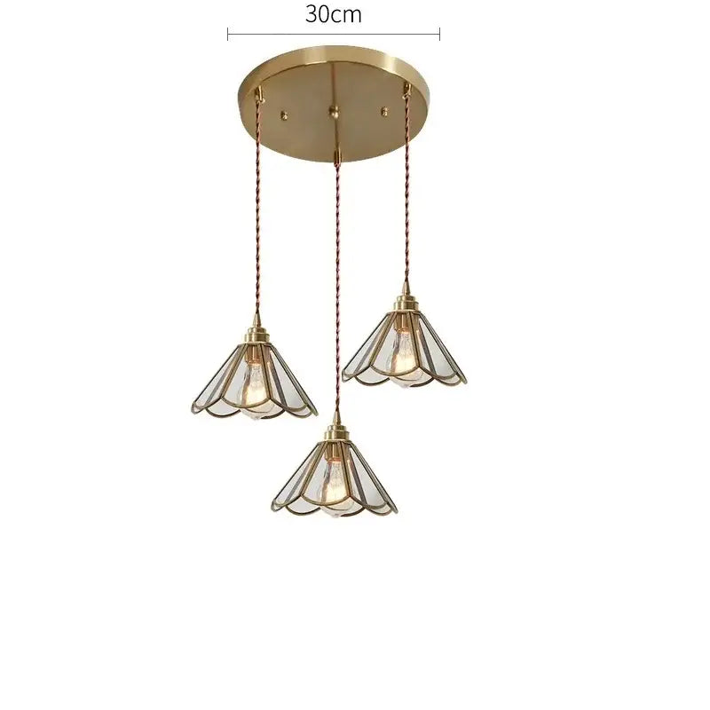 Modern brass glass copper led pendant lights with three clear glass petal shades and twisted cord suspension for dining room