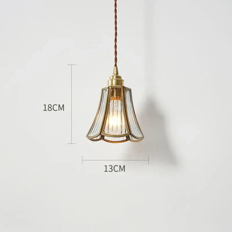 A delicate modern brass glass copper led pendant light with fluted shade and twisted brown cord for dining room