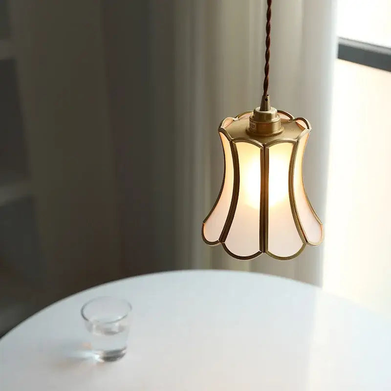 Modern brass glass copper led pendant light with warm-toned brass frame and translucent petal-shaped shade hanging