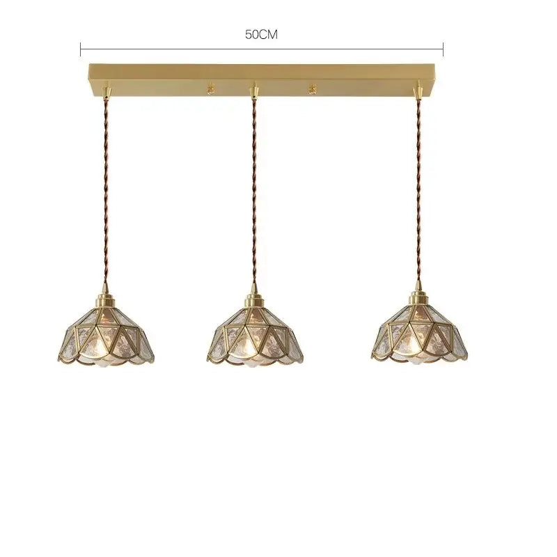 Modern brass glass copper led pendant lights featuring gold-toned three-light geometric shades with twisted copper cords